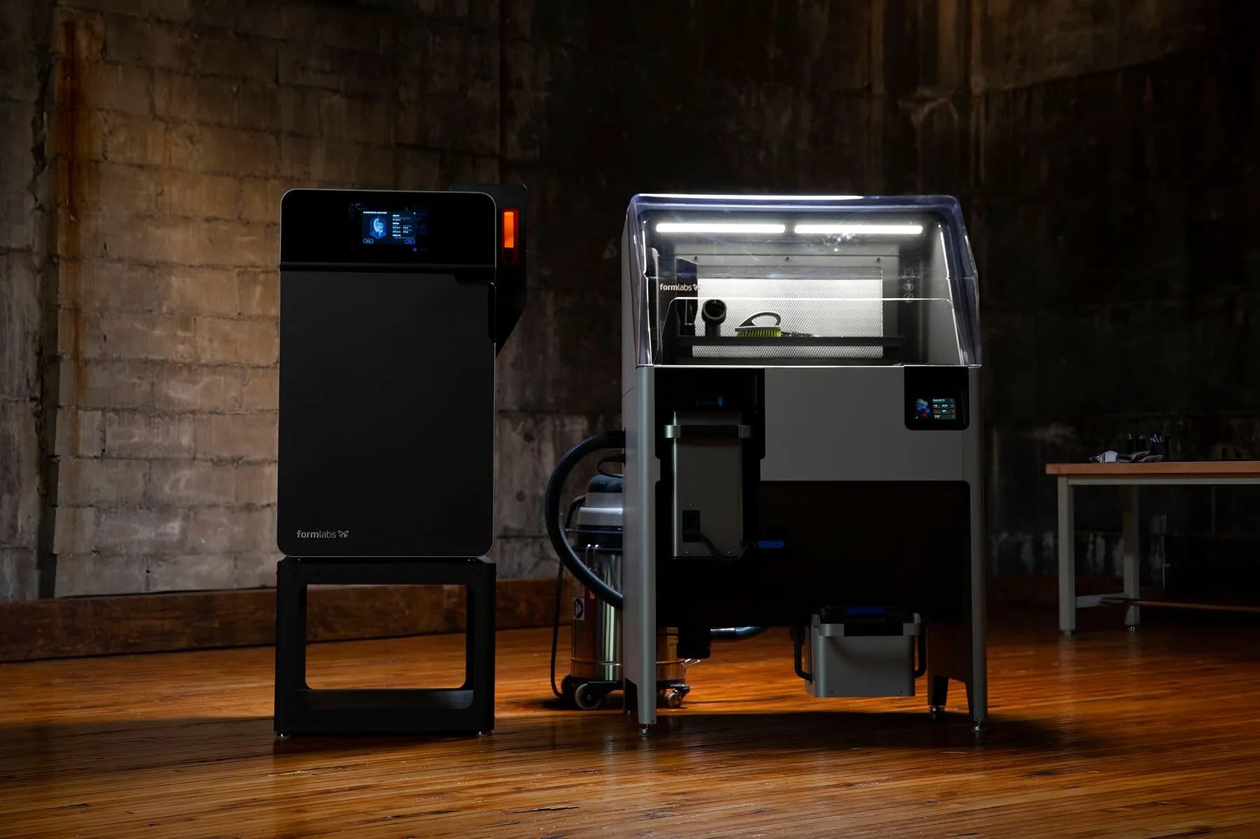 Fuse 1+ 30W printer and Fuse Sift station standing side by side in a workshop.